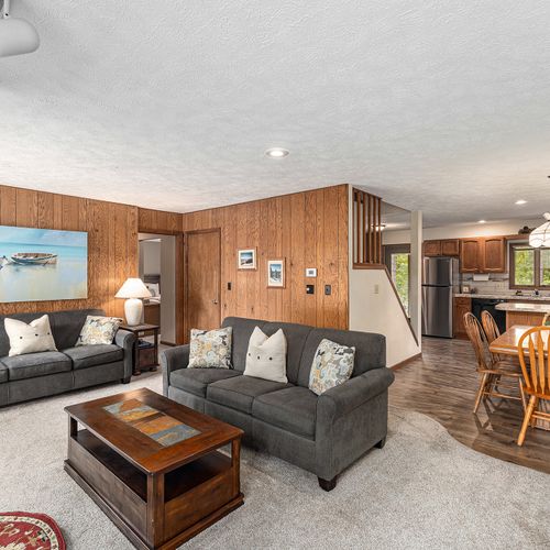 LIVING ROOM:  The large and beautiful living room with wood fireplace and walk-out to the bonfire ring