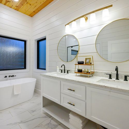 The private bath has a double vanity, walk-in shower and oversized soaking tub.