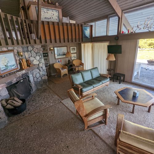 Living room #1:  the large open comfy living room with a tv and fireplace plus lots of windows for plenty of sunlight