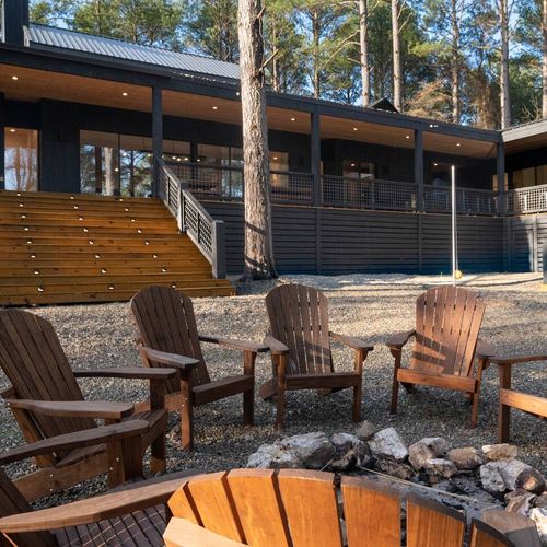 Outdoor firepit with Adirondack chairs.