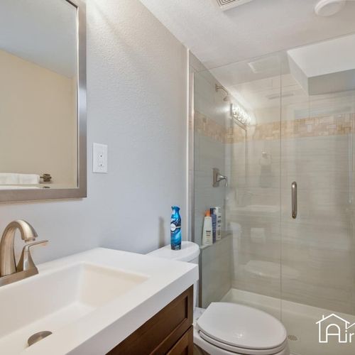 A second ensuite bathroom contain walk-in glass showers and extra wide vanity sink.