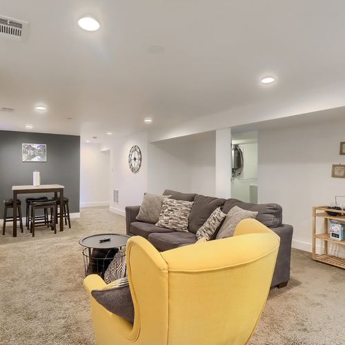 The downstairs living area also includes a mini fridge and microwave, and additional space for lounging and entertaining.