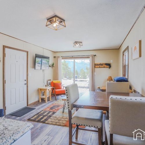 The dining space hosts 3 and opens up to the living space with sliding patio doors.