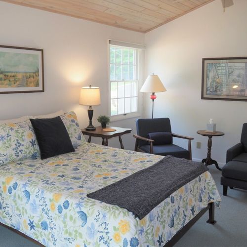 Bedroom #1 (main floor):  huge master bedroom featuring a king-size bed, desk, private television, private en suite full bathroom, chairs, dresser, walk-in closet, and even a private laundry room!