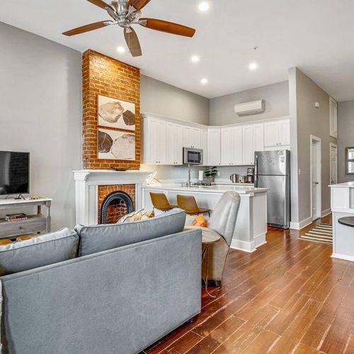 Open living, dining & kitchen space bathed in natural light w/ hardwood floors.
