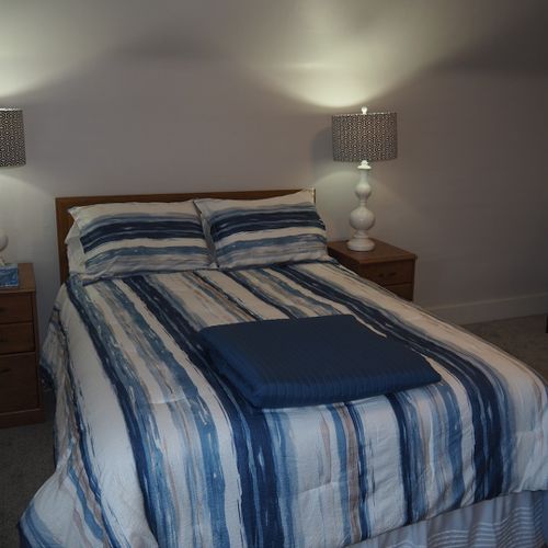 Bedroom #1:  all 3 bedrooms are upstairs. This bedroom features a queen-size bed, nightstands with lamps, dresser, chair, and a large closet.