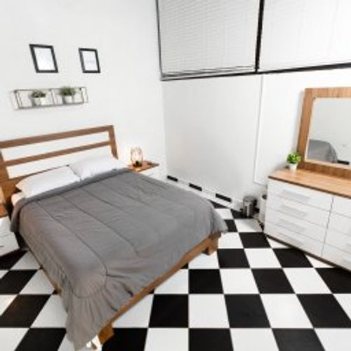 Indulge in peaceful slumber in this elegantly appointed bedroom. A comfortable queen-sized bed, stylish bedside tables with soft lighting, and captivating wall art create a serene and inviting atmosphere. Your perfect night's rest awaits.