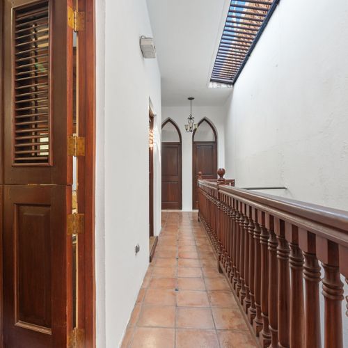 A welcoming corridor leading to an open door, where natural light flows in, creating a bright and airy atmosphere.