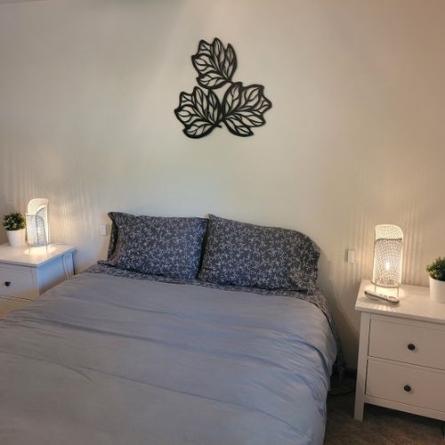 Bedroom #1:  features a sleep number adjustable queen-size bed, closet, ceiling fan, nightstands, and lamps.
