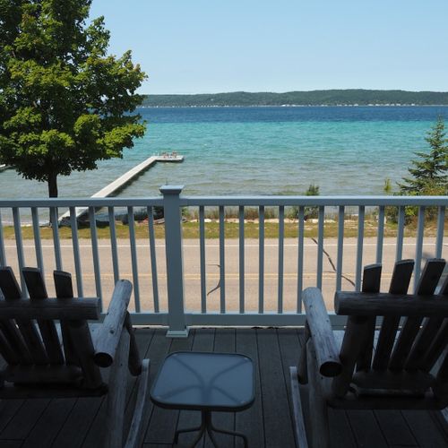 Exterior:  the relaxing adirondack chairs on the deck with the private dock and the lake in the background.