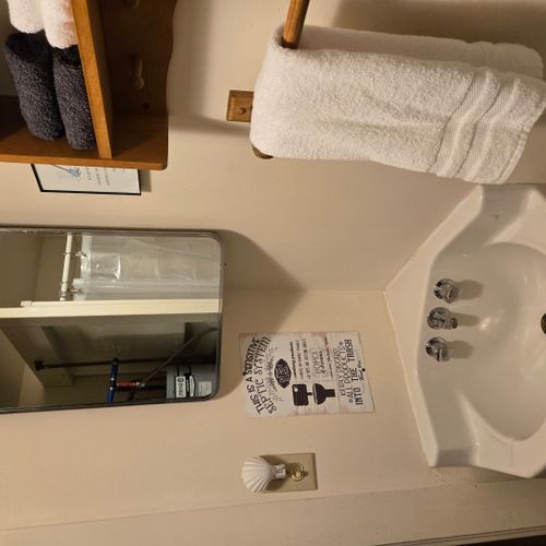 Bathroom:  there is a full bathroom with a shower, sink, vanity, mirror, and toilet.