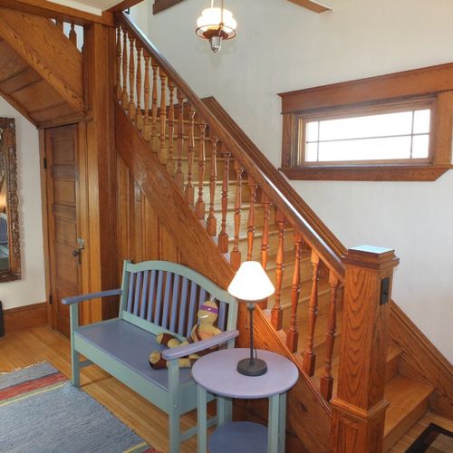 Front foyer:  another angle highlighting the beautiful wooden stairway to the second floor.