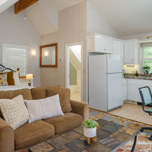 Queen bed for two with a full kitchen, seating area, and full bathroom.