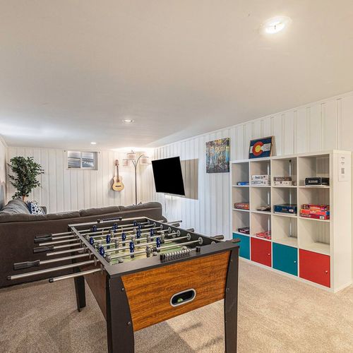 - fully stocked game room with foosball table, board games, and a mounted tv for entertainment
- bookshelves and guitars add charm to this cozy space for groups or families
- relax and play in this fun filled retreat after a day out