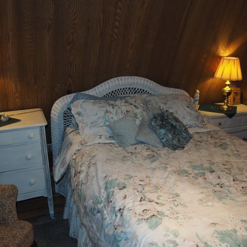 Bedroom:  includes a queen-size bed, dressers, night lamps, ceiling fan, closet, and room a/c unit.