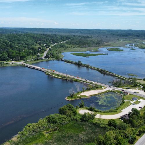 Exterior:  aerial photo of the betsie river as it empties into betsie lake. The bridge is for m22 as it goes from elberta (on the right) into frankfort (on the left).
