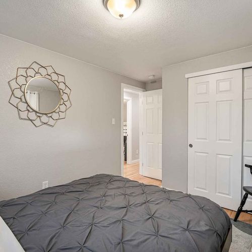 - alternate view of the queen bedroom showing full size closet and stylish wall mirror
- neutral tones, carpeted flooring, and soft bedding create a relaxing retreat
- ideal space to unpack, unwind, and enjoy a peaceful night of rest
