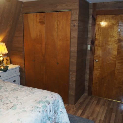 Bedroom:  includes a queen-size bed, dressers, night lamps, ceiling fan, closet, and room a/c unit.