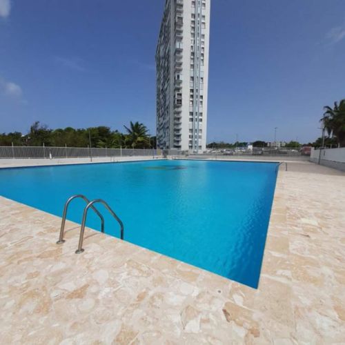 Dive into Paradise: Enjoy a refreshing swim in our sparkling pool, set against a backdrop of modern architecture and tropical skies.