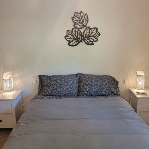Bedroom #1:  features a sleep number adjustable queen-size bed, closet, ceiling fan, nightstands, and lamps.