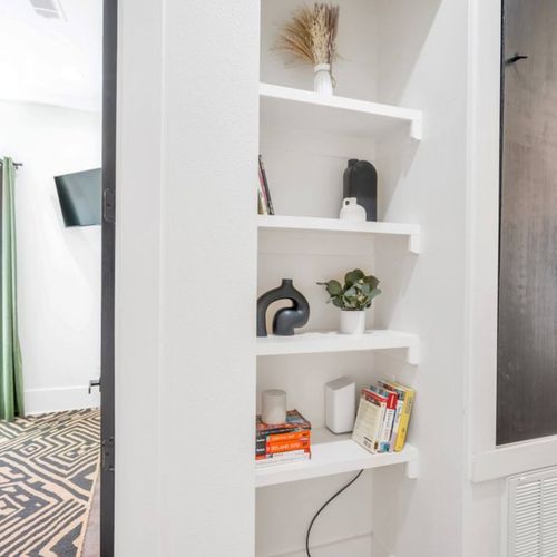 Stylish hallway nook w/ built-in shelves — a charming little detail.