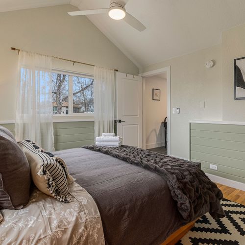 - rise to sunlight streaming in through airy curtains and a vaulted ceiling
- rest easy on plush cozy bedding with earthy textures and modern art accents
- quiet mornings start here with fresh linens and a peaceful neighborhood view
