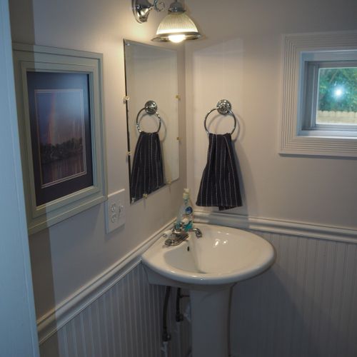 Bathroom #1  (downstairs):  the downstairs has a convenient half-bath next to the laundry room. It has a toilet, pedestal sink, and mirror.