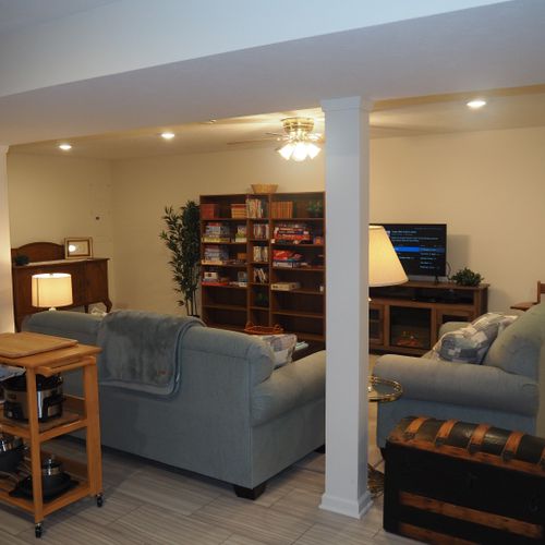 Living room:  the apartment has a very comfortable living room with a sleeper sofa, comfy chair, ceiling fan, table, and television.