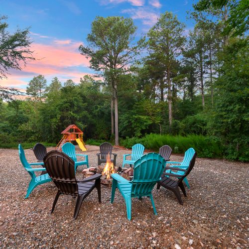 A fire pit with chairs.