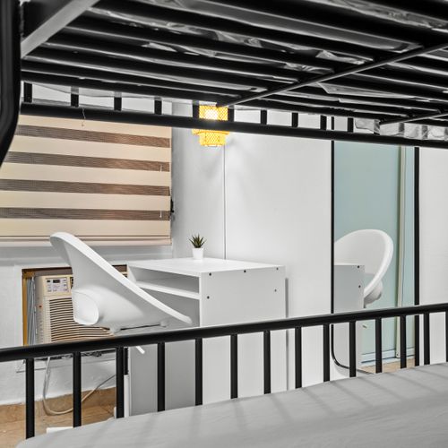 Peek into the study space under the top bunk, a clever use of space perfect for reading or catching up on work, bathed in natural light.