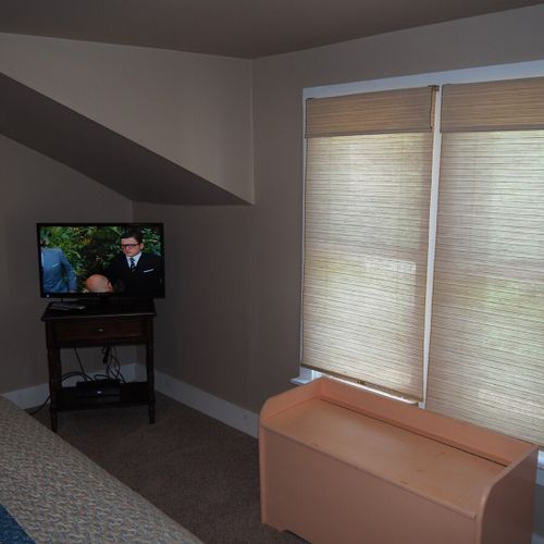 Bedroom #1:  features a queen-size bed, mirror, nightstands, lamps, dresser, chair, and television.
