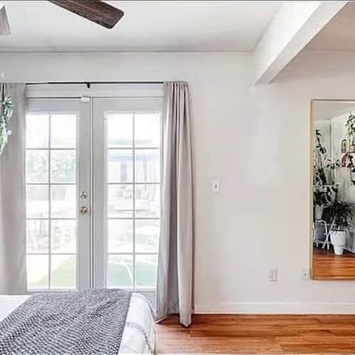 Peaceful corner bedroom with garden views.