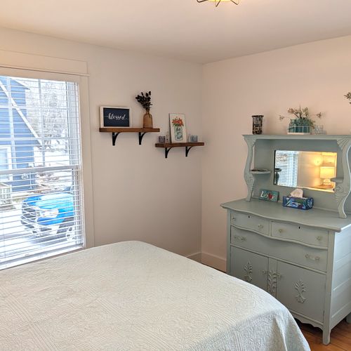 BEDROOM #2 (MAIN FLOOR):  This is a second main floor bedroom that also has a queen-size bed, nightstands, lamps, dresser, mirror, and a closet.