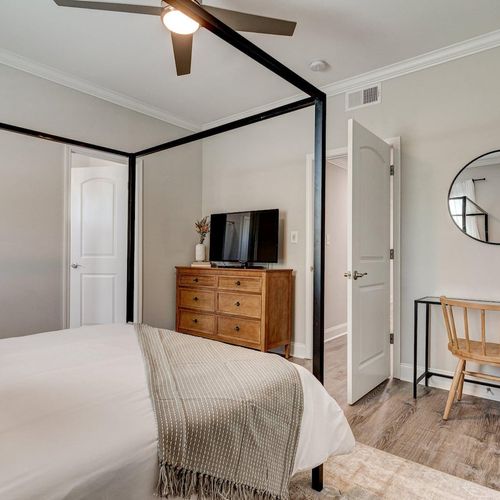 Sun-filled bedroom w/ a desk nook — great for unwinding or getting work done.