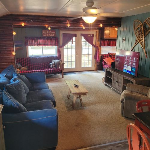 Living room:  large and comfy living room with a sofa, comfy chair, coffee table, and streaming television.
