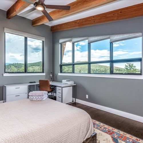 A private loft bedroom complete with queen-sized bed, desk and printer for your remote work needs.