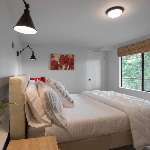 Private downstairs guest bedroom overlooking the trees and water.