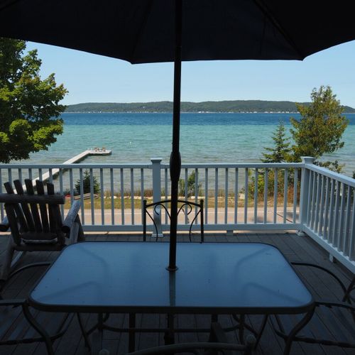 Exterior:  the dining table on the deck with the lake in the background.
