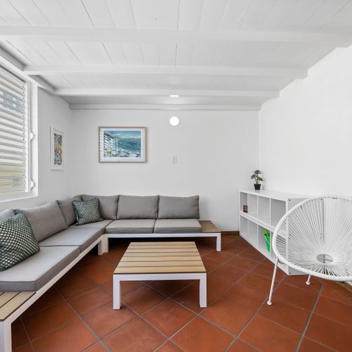 Relax in style in this inviting living room. Featuring a comfortable sectional sofa, perfect for lounging, and a stylish coffee table, this space is designed for both comfort and conversation.