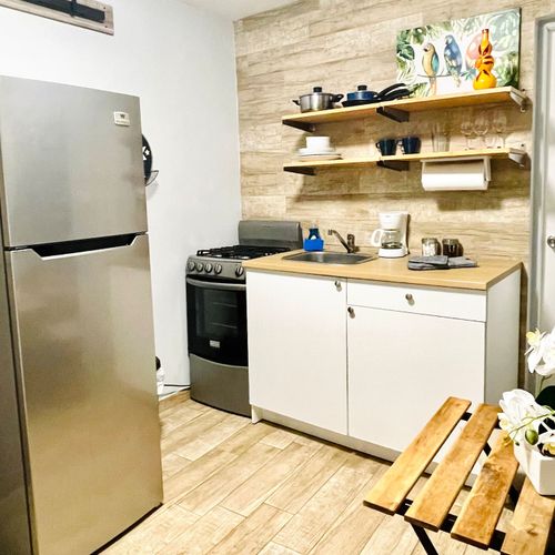 Whip up delicious meals with ease! Our fully-equipped kitchenette includes a gas range, pots, and pans, perfect for home-cooked convenience.