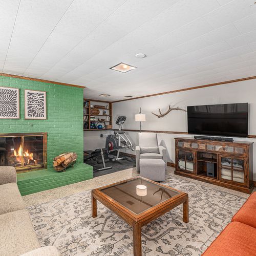 Unwind in this spacious living area, complete with a large tv for movie nights and an elliptical for keeping up with your fitness routine, all in one cozy space.