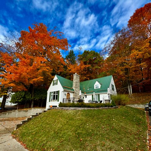 EXTERIOR:  A gorgeous view of the home looking up from the street in the fall.