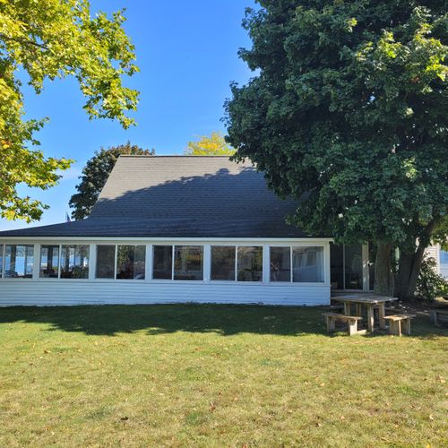 EXTERIOR:  The view of the cottage from the south, with the 2 picnic tables highlighted in the photo.