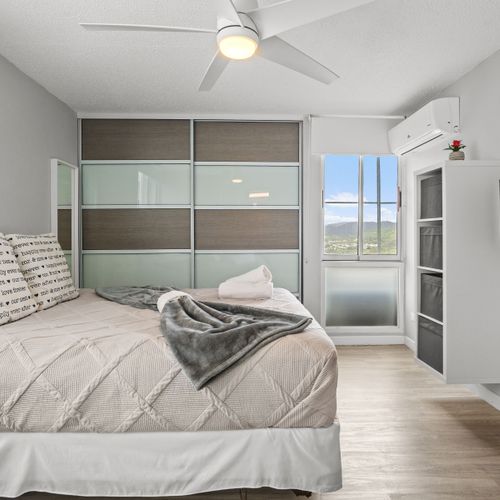 Indulge in quiet comfort. This beautifully appointed primary bedroom promises restful nights and serene mornings, with thoughtful touches for a truly relaxing stay.