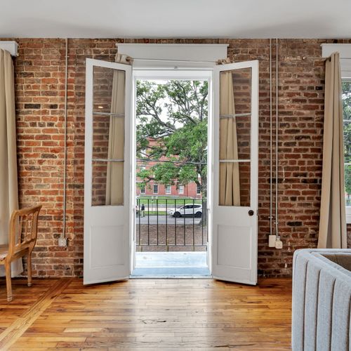 Unwind in the spacious living area adorned with comfortable seating and a flat-screen TV, seamlessly extending to a private balcony where you can enjoy panoramic city views and vibrant sunsets