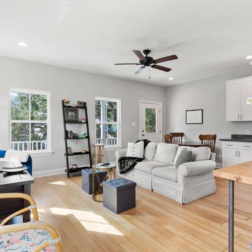 Sun-filled living room w/ plush seating — the perfect spot to relax & unwind.
