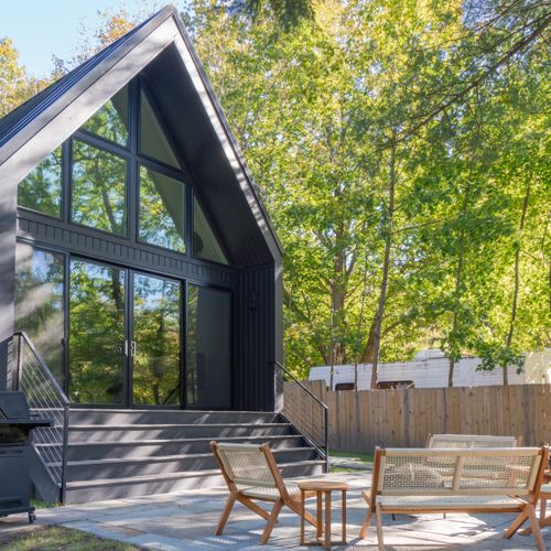 Back patio views of the property, surrounded by lines of trees.