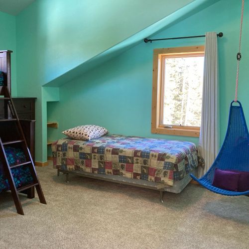 A kids' haven: bunk beds + one twin bed +a swinging chair.