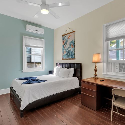 Sun-filled bedroom w/ crisp bedding for a peaceful night's rest.