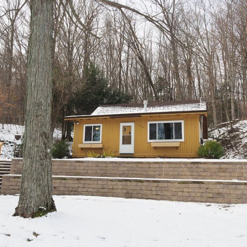 Exterior:  the outside of the cabin in the winter.